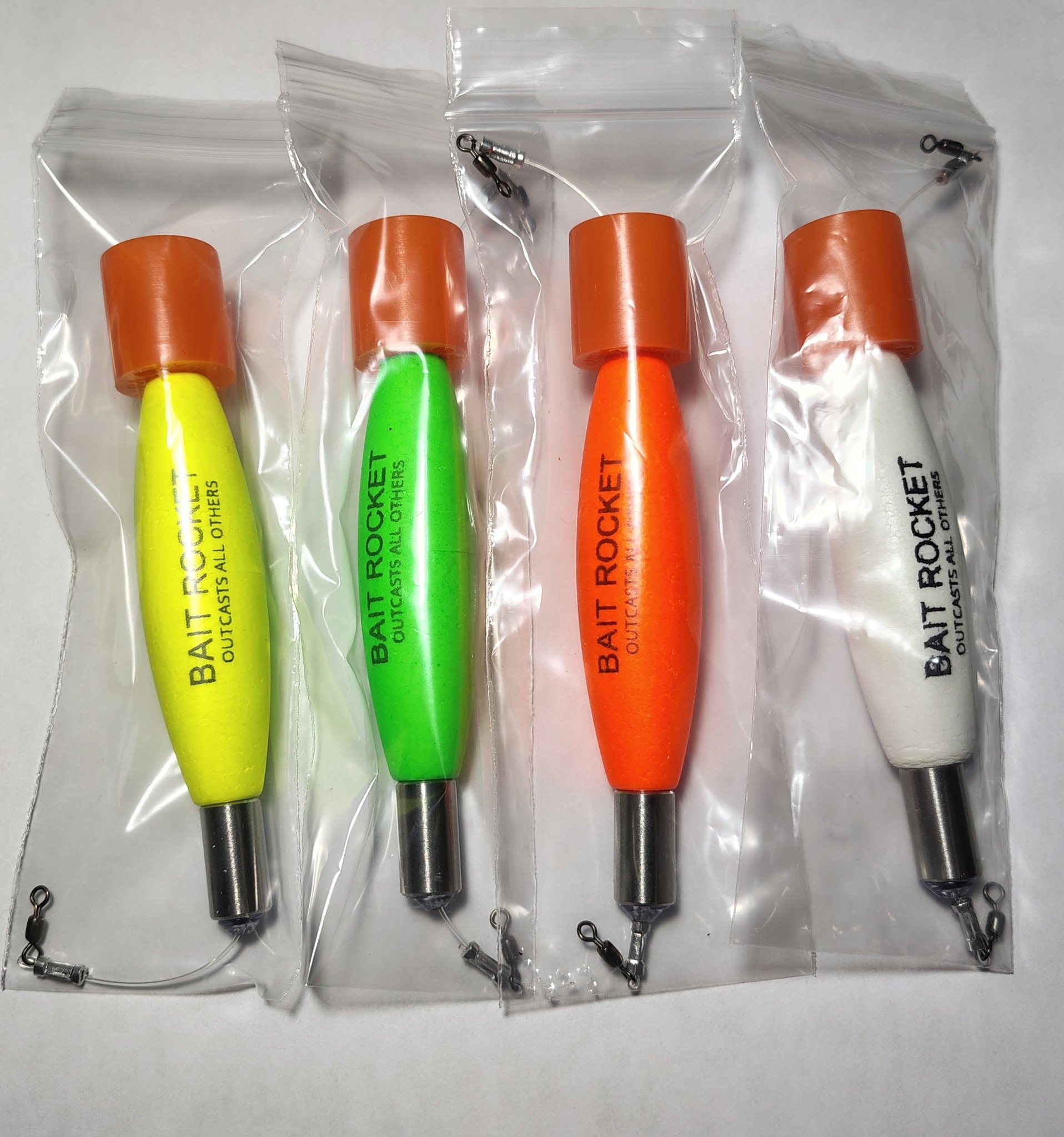 All four Bait Rocket™ popping cork colorways — hi-vis yellow, atomic green, blaze orange and glow white — lined up in their packaging.